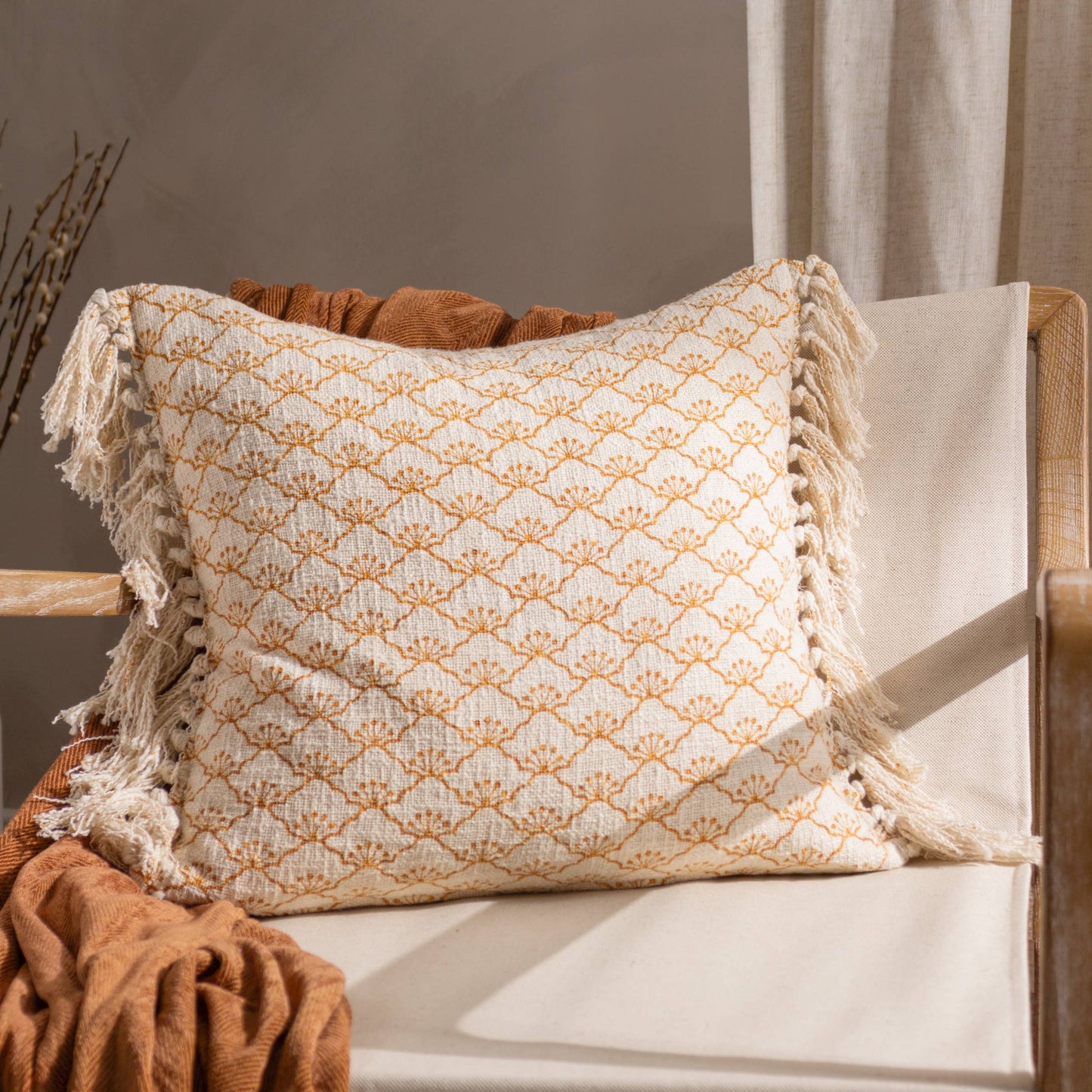Boho tassel cushion in ecru and mastard