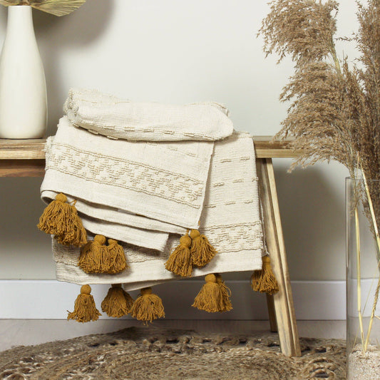 cotton throw, tufted design with ochre yellow tassels